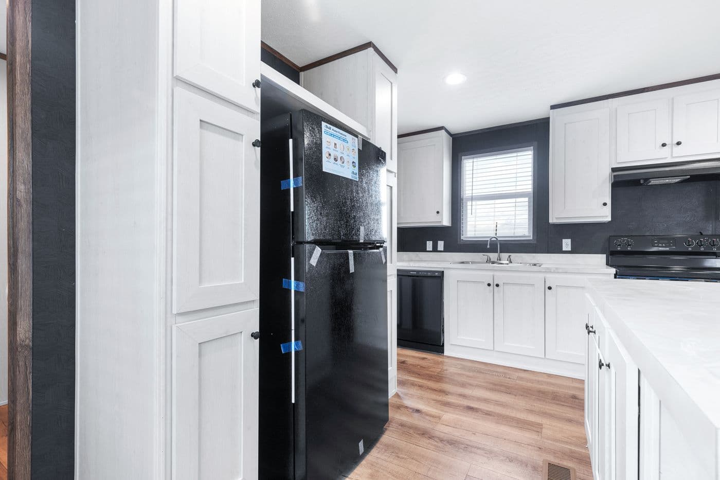 The HOMESTEAD 16602A Kitchen. This Manufactured Mobile Home features 2 bedrooms and 2 baths.