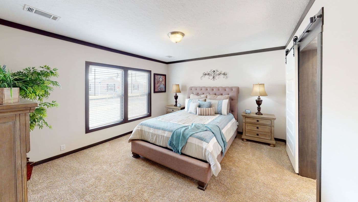 The BOUJEE XL 2 Primary Bedroom. This Manufactured Mobile Home features 4 bedrooms and 3 baths.