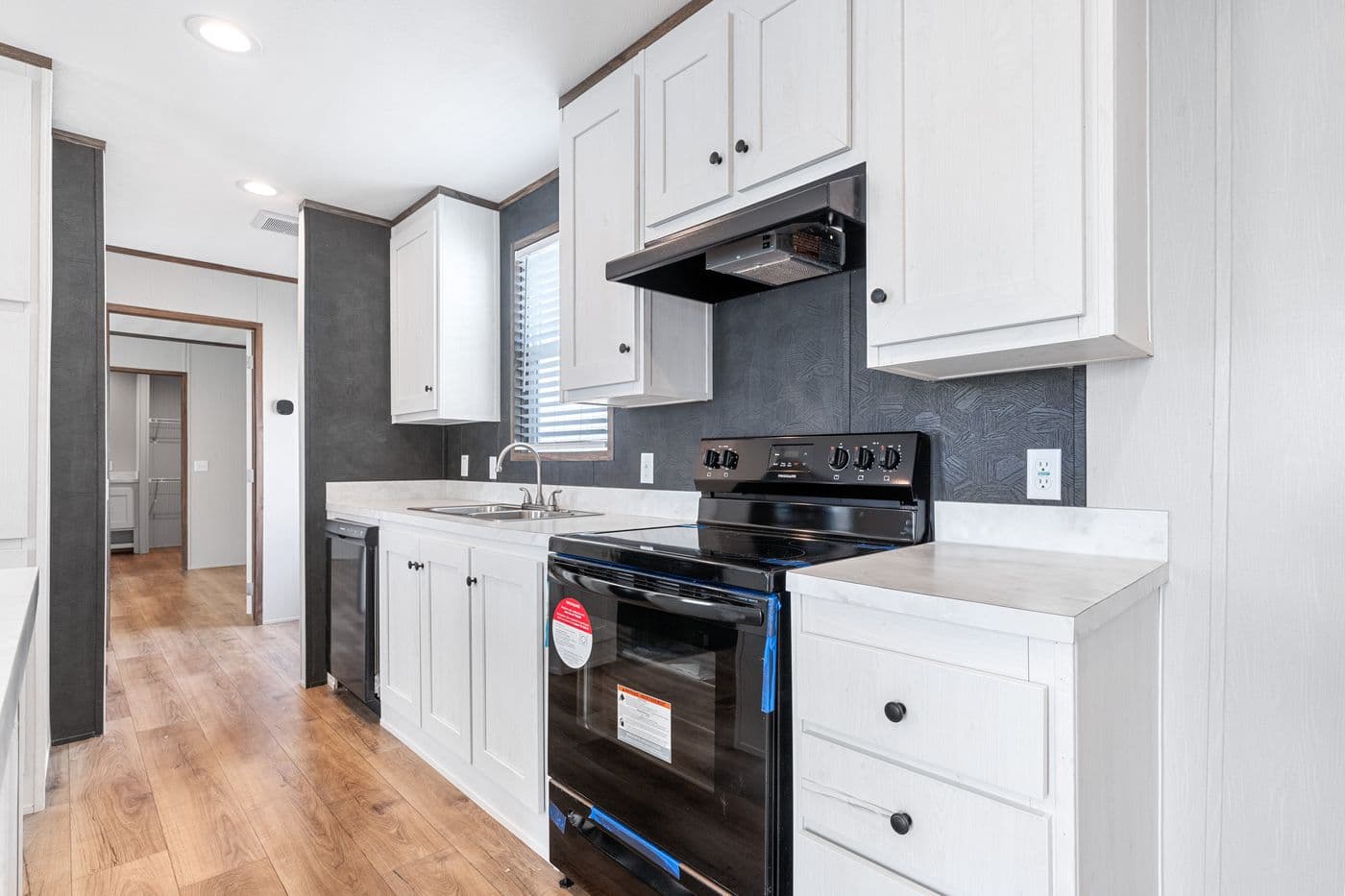 The HOMESTEAD 16683A Kitchen. This Manufactured Mobile Home features 3 bedrooms and 2 baths.