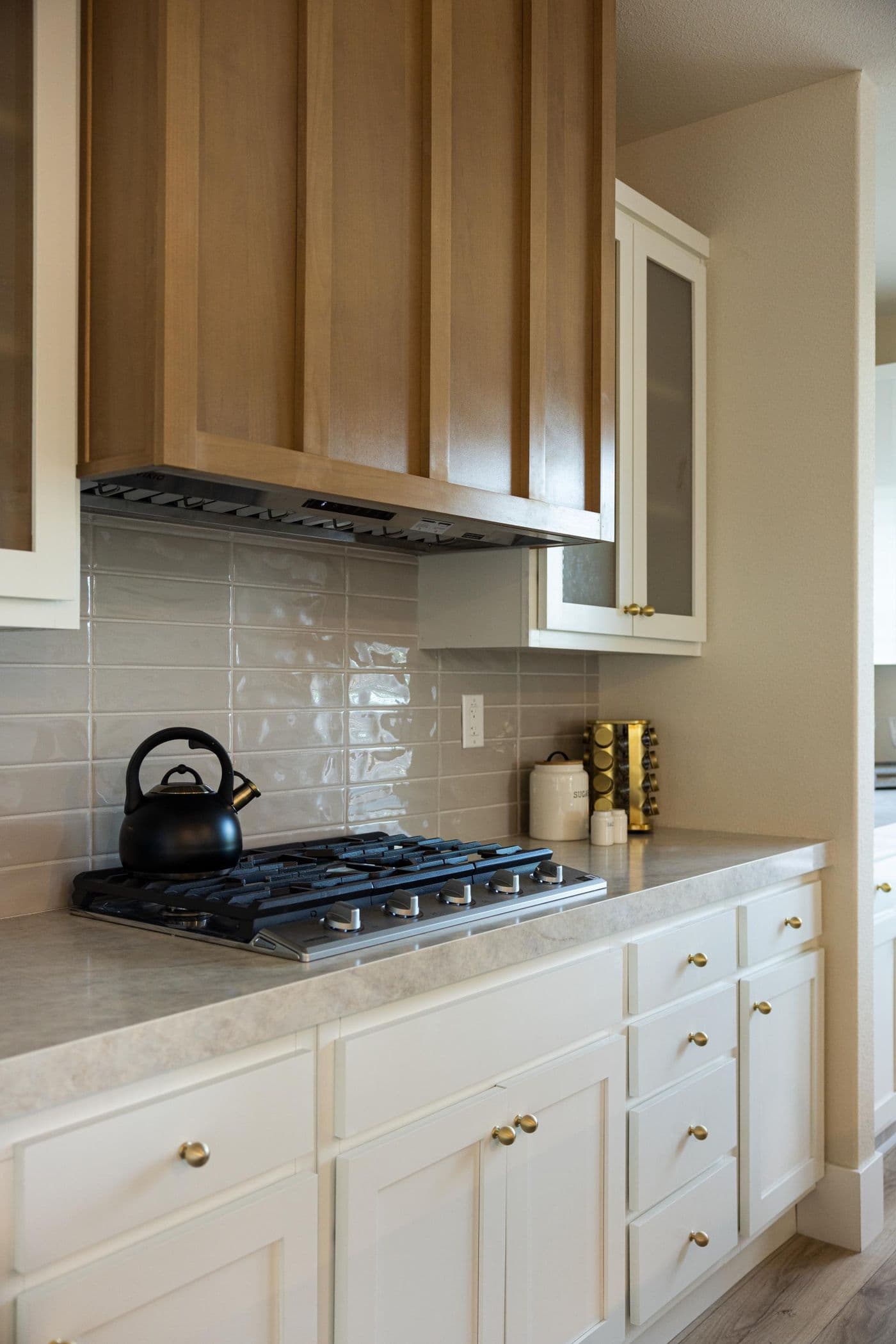 The ELEANOR Exterior. This modern manufactured home features an elevated kitchen with an island, built-in oven, and gas range.
