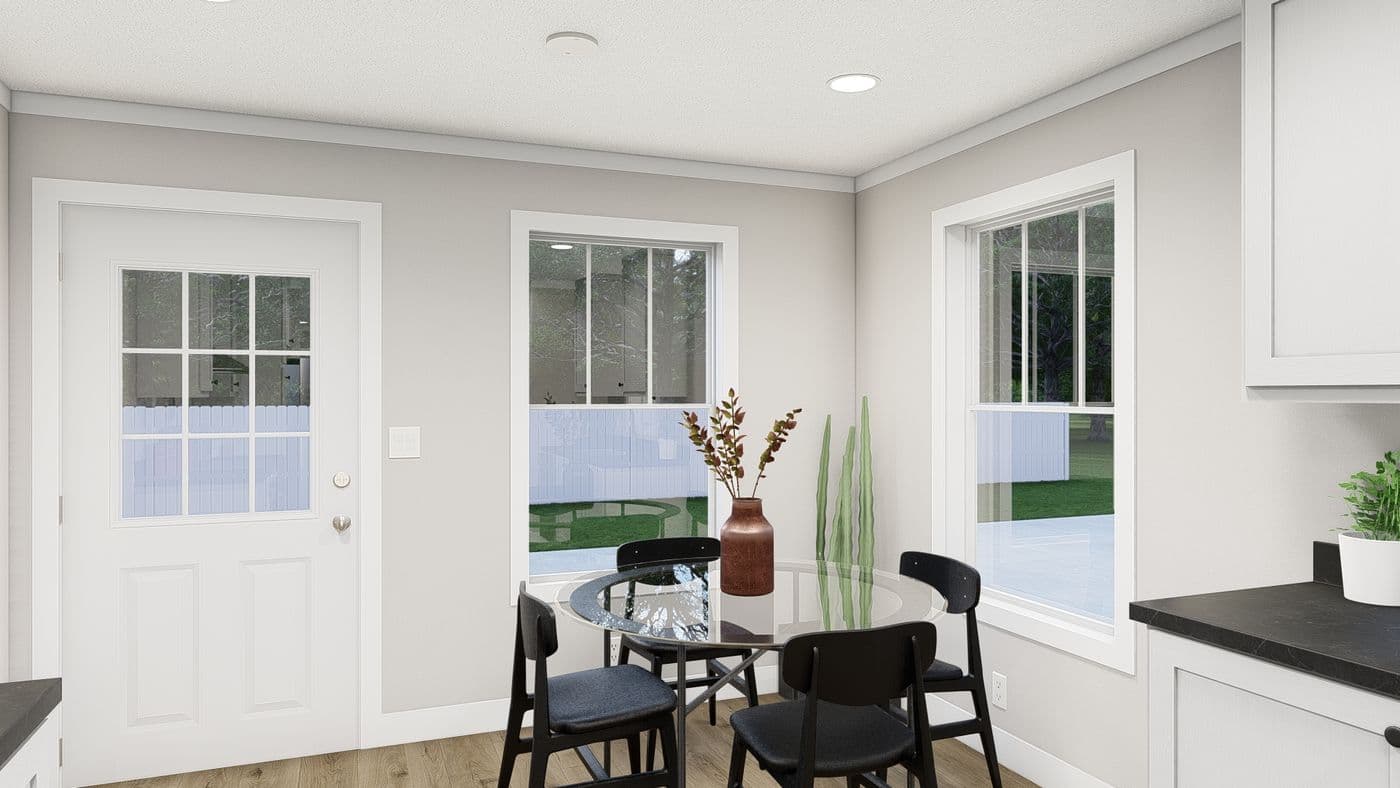 The HERE COMES THE SUN Dining Area. This Manufactured Mobile Home features 3 bedrooms and 2 baths.