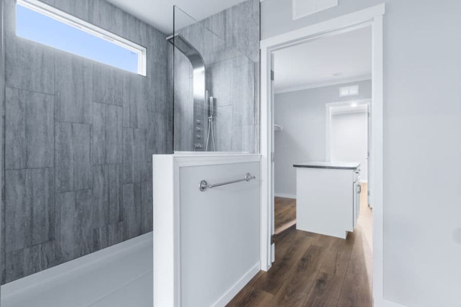 The THE OLYMPUS Primary Bathroom. This Manufactured Mobile Home features 4 bedrooms and 3 baths.